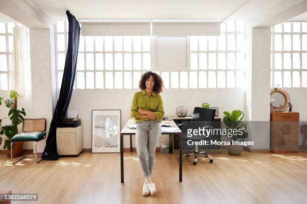 female entrepreneur standing with arms crossed - entrepreneur foto e immagini stock