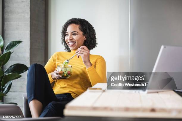 happy businesswoman with salad bowl at work place - lunch break stock pictures, royalty-free photos & images
