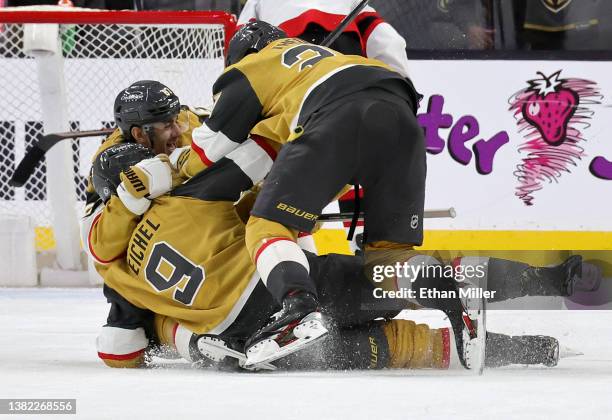 Jack Eichel of the Vegas Golden Knights is tackled by teammates Max Pacioretty and and Shea Theodore after Eichel scored a power-play goal with 5.9...