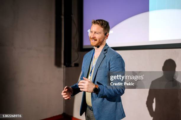 young casually clothed man giving a speech on a conference - awards ceremony stock pictures, royalty-free photos & images