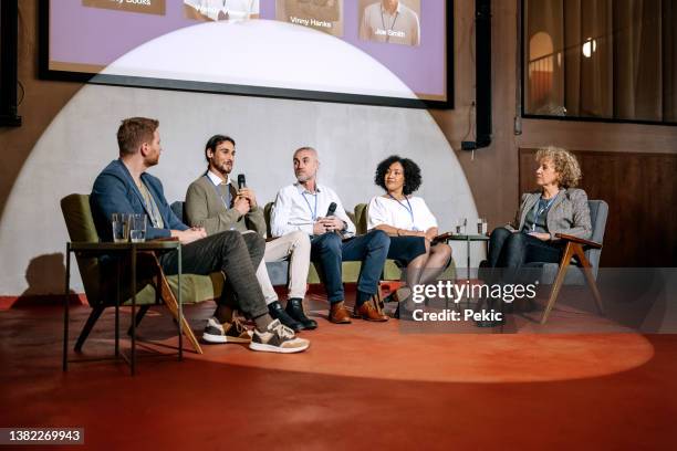 group of diverse business people on panel discussion - presenting imagens e fotografias de stock