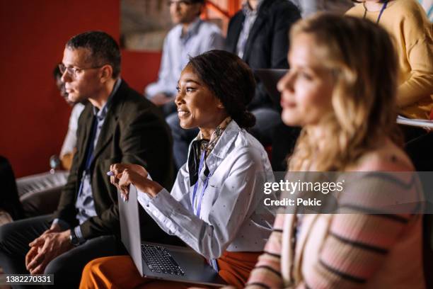 young beautiful woman attending business conference - attending seminar stock pictures, royalty-free photos & images