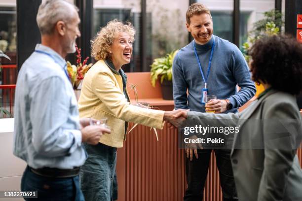 business people on a break while attending business conference - business conference event stock pictures, royalty-free photos & images