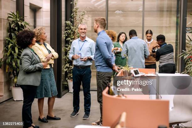 group of business people having casual conversation while on a refreshment break - informal meeting of ministers for employment and social affairs stockfoto's en -beelden