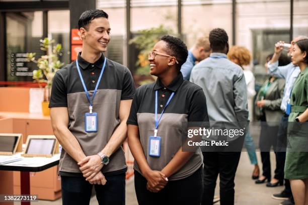 receptionist staff at conference event - employee badge stock pictures, royalty-free photos & images