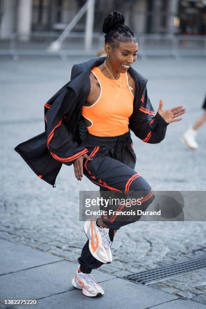 Nia Dennis poses with Stella McCartney gym suit and white sneakers after the Stella McCartney on March 07, 2022 in Paris, France.