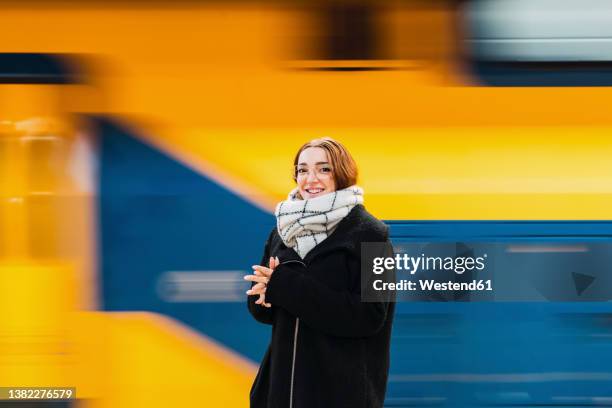 smiling young woman with eyeglasses by subway train - station stock pictures, royalty-free photos & images