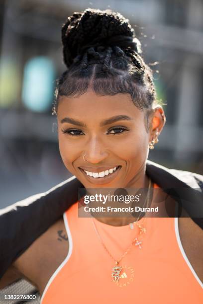 Nia Dennis poses with Stella McCartney gym suit and white sneakers after the Stella McCartney on March 07, 2022 in Paris, France.