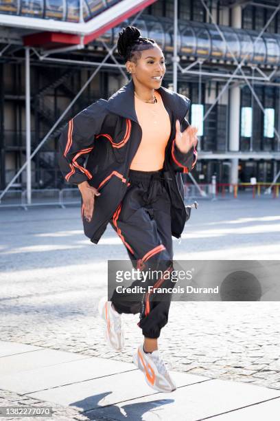 Nia Dennis poses with Stella McCartney gym suit and white sneakers after the Stella McCartney show on March 07, 2022 in Paris, France.