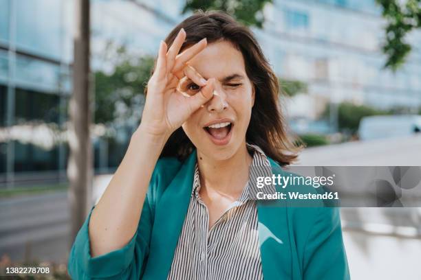 happy businesswoman in smart casuals making ok gesture sign with hand - ok hand sign stock pictures, royalty-free photos & images