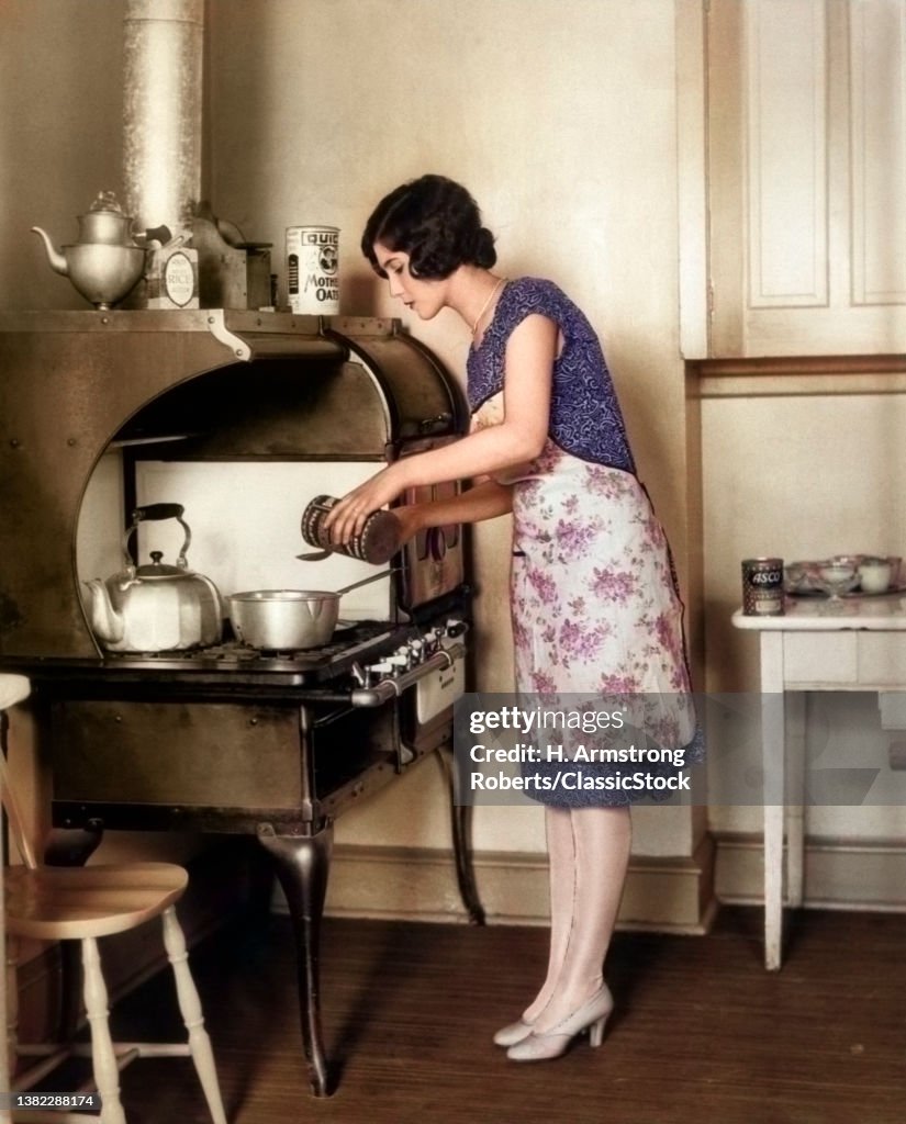 1920s Housewife At Gas Stov...