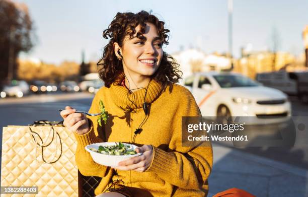 woman having salad sitting on footpath - music from the motor city stock pictures, royalty-free photos & images