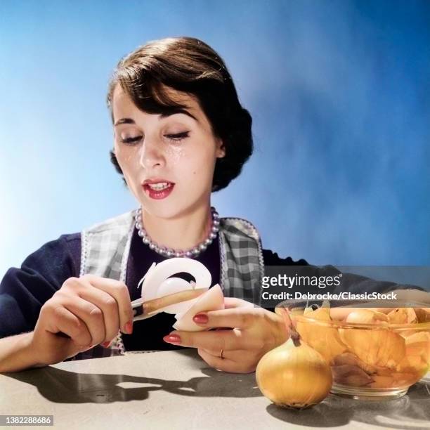 1950s 1960s Woman Housewife Cook Reacting To Peeling Onion Crying Tears.
