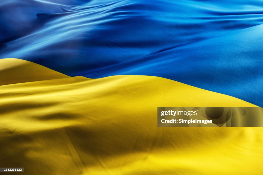 Ukrainian flag blowing in the morning light.