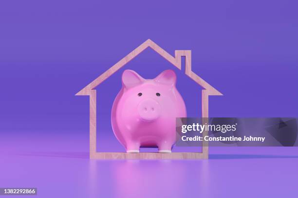 piggy bank and wooden house shape. mortgage loan and home ownership. - property prices continue to increase stock-fotos und bilder