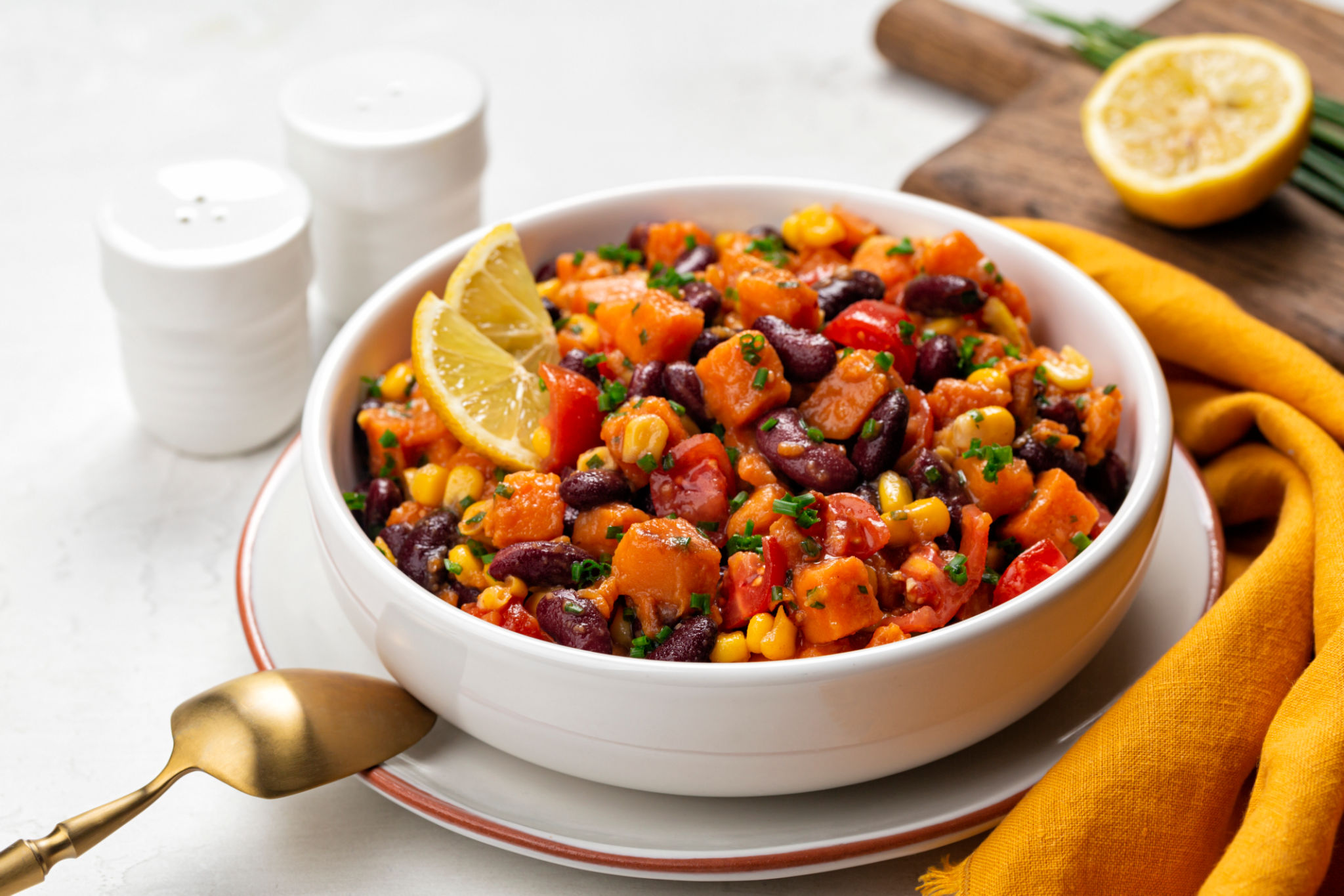 Sweet Potato Salad with roasted sweet potatoes, black beans, corn, tomato, green onion and light honey lemon dressing. Closeup. Sweet Potato Salad with roasted sweet potatoes, black beans, corn, tomato, green onion and light honey lemon dressing. Closeup.