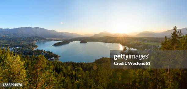 view of lake faak at sunset with karawanks mountains in background - carinthia stock pictures, royalty-free photos & images