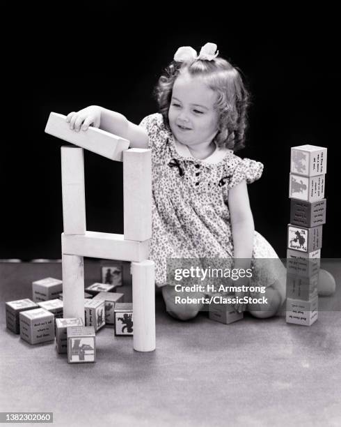 1930s Little Girl With Baloney Curls Playing With Building And Alphabet Blocks.