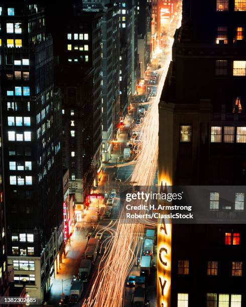 1970s Night Scene Looking Up 7Th Avenue From Macy's Department Store Toward Times Square New York City US.
