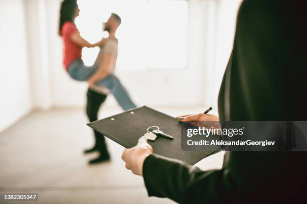 real estate agent preparing apartment key for dancing couple - real estate developer 個照片及圖片檔