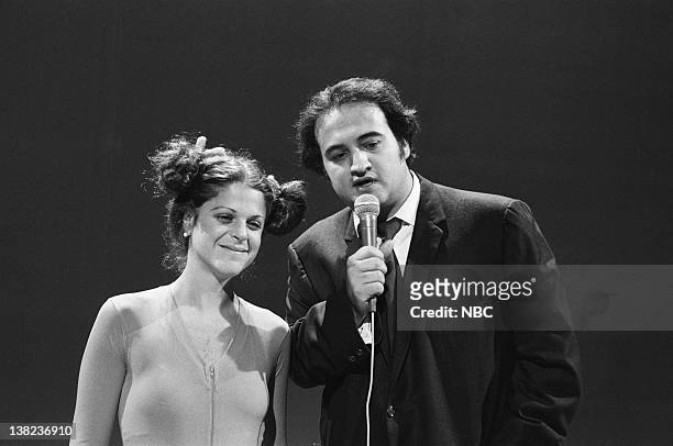 Episode 23 -- Air Date -- Pictured: Gilda Radner as Olga Korbut and John Belushi during the "Weekend Update" skit on July 24, 1976