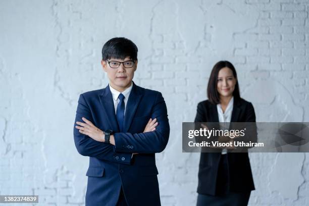 portrait of happy business man and woman posing with arms crossed,insurance and marketing business,concept of financial. - company president stock pictures, royalty-free photos & images