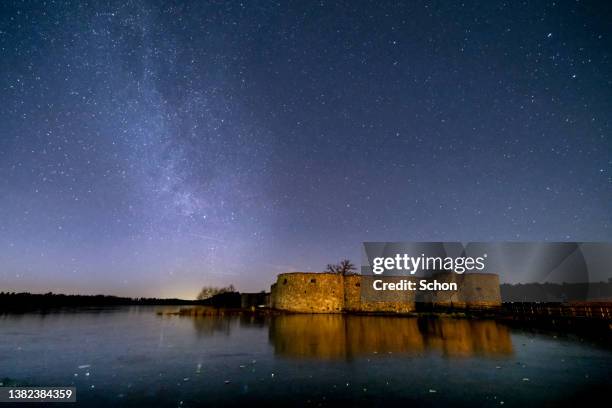 starry sky over an ancient castle ruin - vaxjo stock pictures, royalty-free photos & images