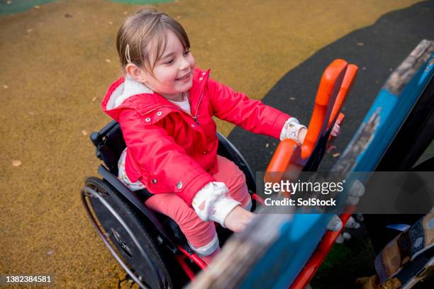 enjoying the playground - disabled accessibility stock pictures, royalty-free photos & images