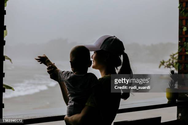 woman at the window in a rough sea - indonesia women stockfoto's en -beelden