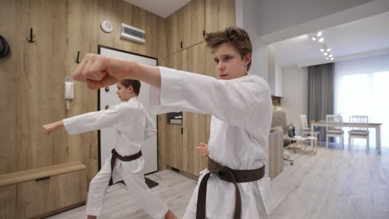 https://media.gettyimages.com/id/1382447544/video/two-teenage-boys-training-karate-at-home.jpg?b=1&s=640x640&k=20&c=dDSxtEqJmW7YZ4Bd9AIVu7KOtLc0w6uCz2Gk0mNyGCw=