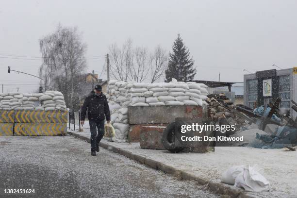 Man walks through a checkpoint in heavy snow on March 07, 2022 in Lviv, Ukraine. Ukrainians from the eastern and central parts of the country have...