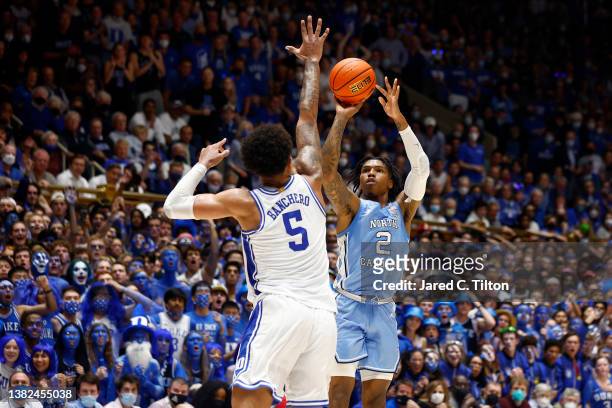 Caleb Love of the North Carolina Tar Heels attempts a jump shot over Paolo Banchero of the Duke Blue Devils during the first half of the game at...
