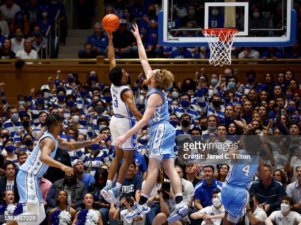 Jeremy Roach of the Duke Blue Devils attempts a shot against Brady Manek of the North Carolina Tar Heels during the first half of the game at Cameron...