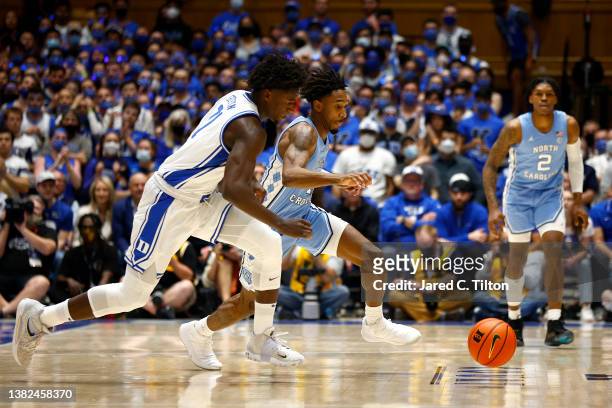 Griffin of the Duke Blue Devils and Leaky Black of the North Carolina Tar Heels battle for a loose ball during the first half of the game at Cameron...