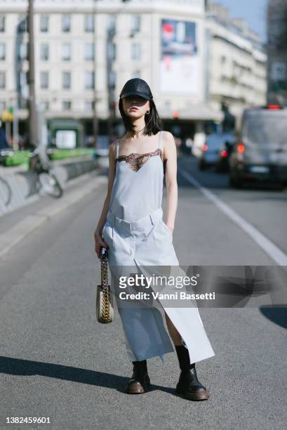 Meng Mao poses wearing a Sacai dress and a Stella McCartney bag after the Sacai show at the Hotel de Ville during Paris Fashion Week - Womenswear F/W...