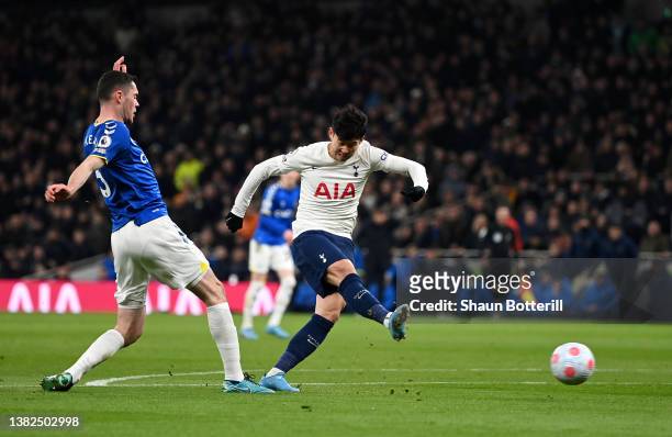 Heung-Min Son of Tottenham Hotspur scores their sides second goal whilst under pressure from Michael Keane of Everton during the Premier League match...