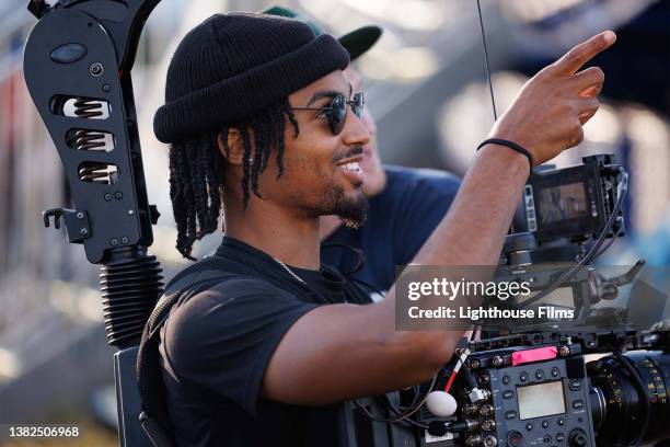 camera operator smiles while filming - film maker stock pictures, royalty-free photos & images