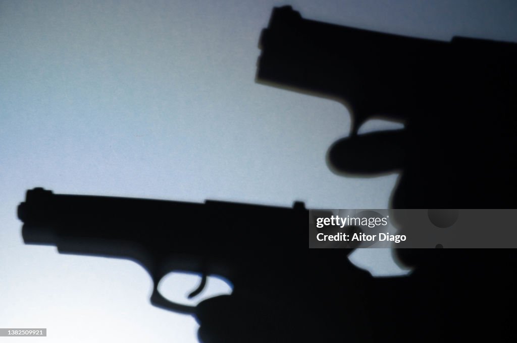 Silhouette two persons with guns ready to shoot. War concept.