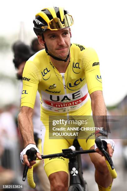 Team Emirates' British rider Adam Yates wearing the overall leader's yellow jersey awaits the start of the 2nd stage of the 110th edition of the Tour...