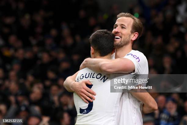 Harry Kane of Tottenham Hotspur celebrates with team mate Sergio Reguilon after scoring their sides fifth goal during the Premier League match...