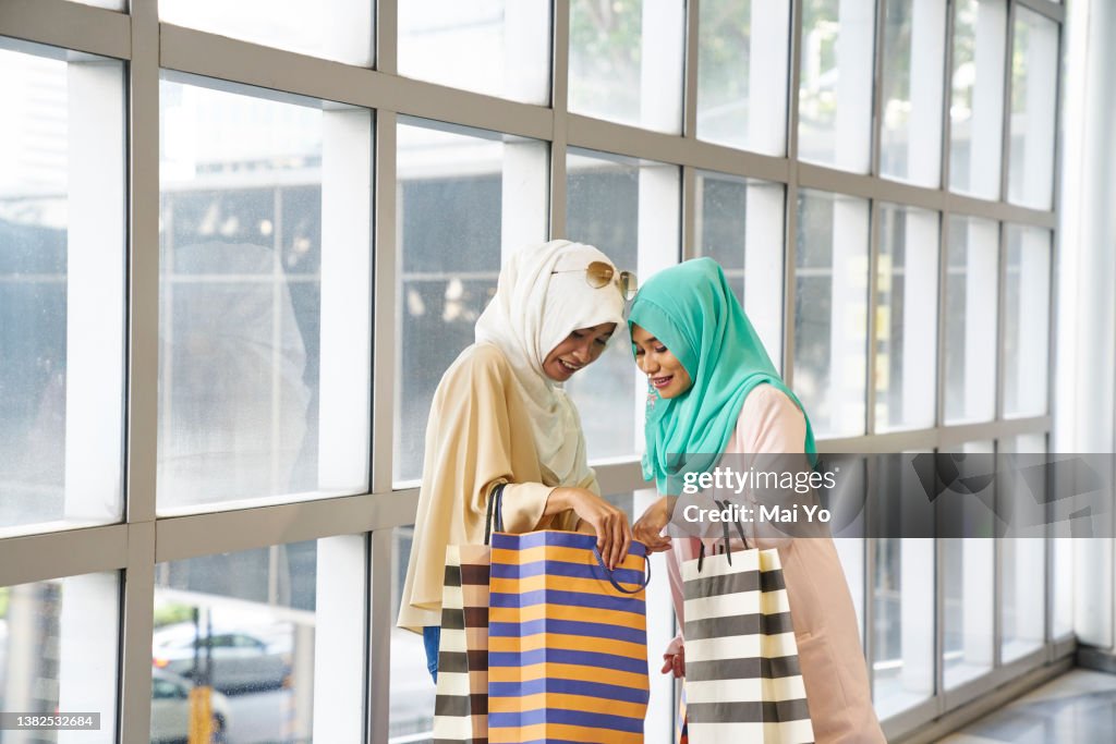 Beautiful women in Hijabs shopping in Raffles Place, Singapore