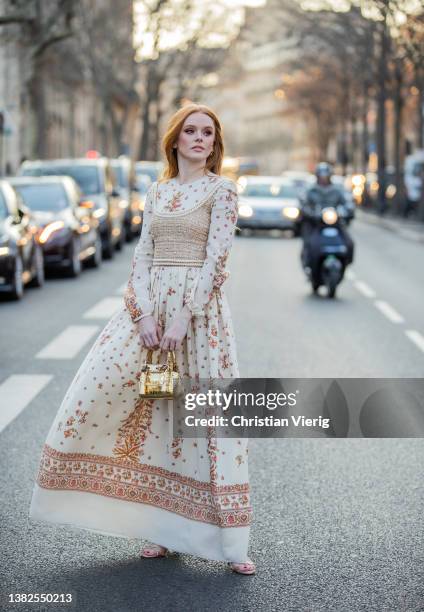 Actress Abigail Cowen is seen wearing latte dress with floral print, golden bag, beige topoutside Giambattista Valli during Paris Fashion Week -...