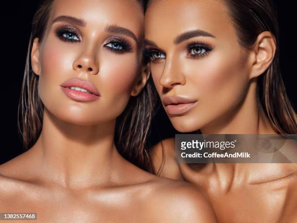 two beautiful emotional women with perfect make-up - beauty woman glow face stock pictures, royalty-free photos & images