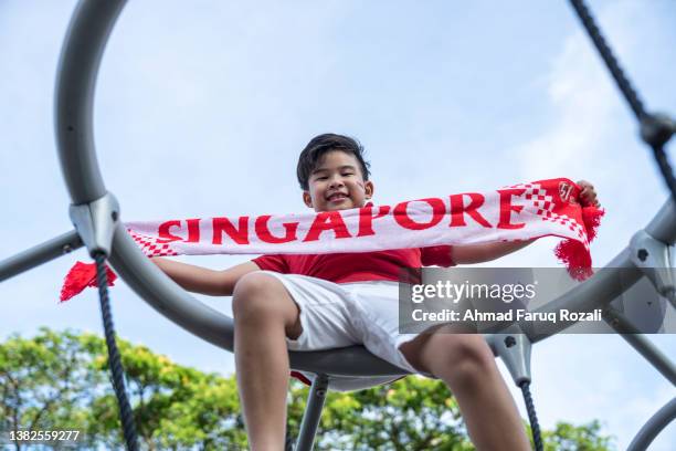 a proud singaporean kid - singapore-national-day stock pictures, royalty-free photos & images