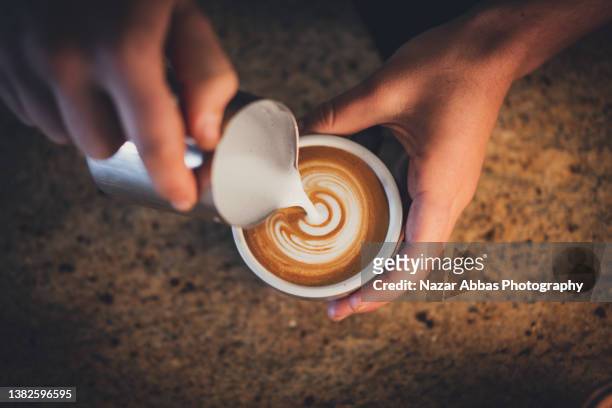 barista coffee in making. - coffee art stockfoto's en -beelden