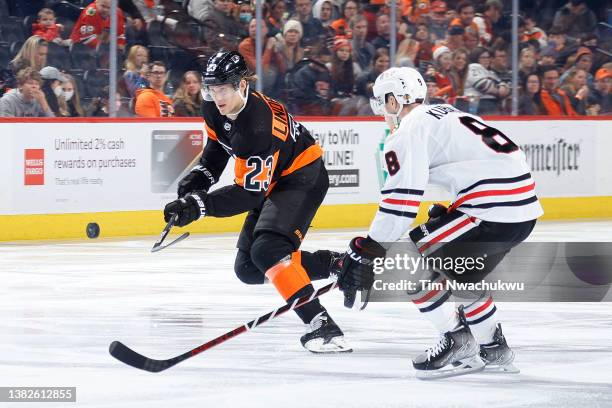 Oskar Lindblom of the Philadelphia Flyers and Dominik Kubalik of the Chicago Blackhawks chase the puck at Wells Fargo Center on March 05, 2022 in...