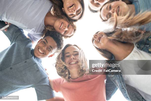 teenagers huddled outside - college campus aerial stock pictures, royalty-free photos & images