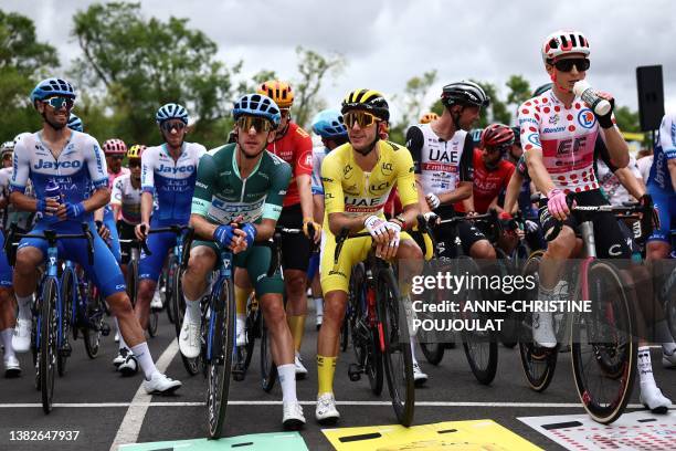 Team Jayco Alula's British rider Simon Yates wearing the best sprinter's green jersey and his brother UAE Team Emirates' British rider Adam Yates...