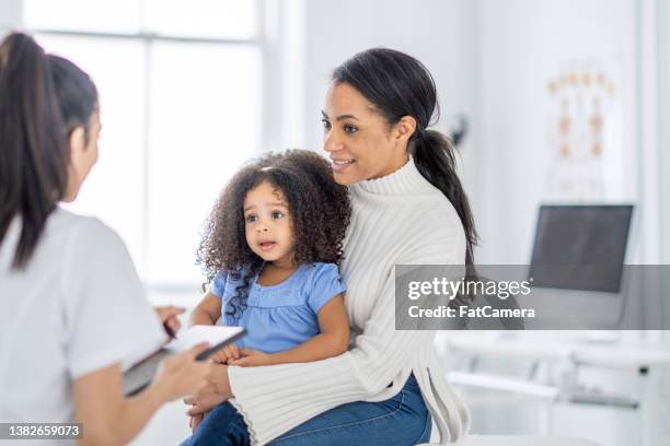 mother and daughter health history - doctor child stock pictures, royalty-free photos & images