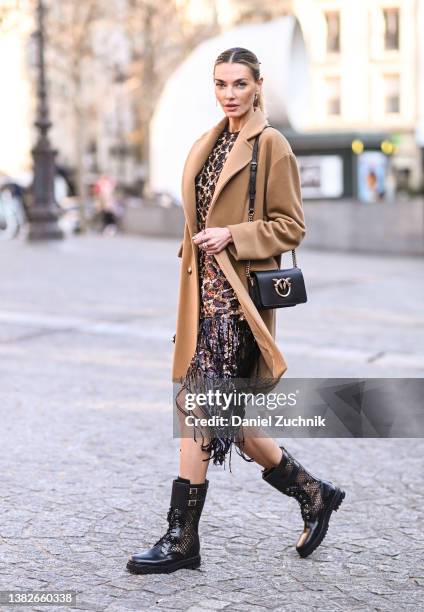 Alina Baikova is seen wearing a tan coat and animal print Stella McCartney dress outside the Stella McCartney show during Paris Fashion Week A/W 2022...